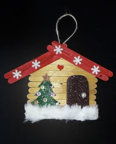 a wooden house ornament with a christmas tree on it