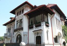 a large white building with lots of windows and balconies on the second floor