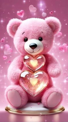 a pink teddy bear with two hearts on it's chest sitting in front of a pink background