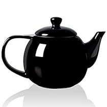 a black teapot with a lid and handle on a white background, it appears to be empty