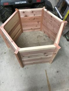 a wooden planter sitting on top of a cement floor