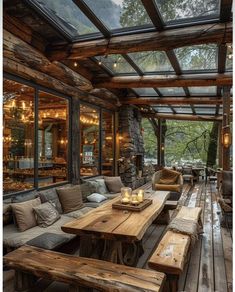 a large wooden table sitting under a glass roof