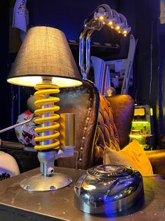 a lamp sitting on top of a table next to a chair and other furniture in a room