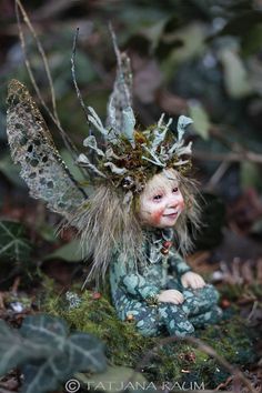 a small fairy doll sitting on the ground