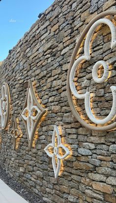 a stone wall with decorative numbers on it