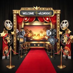 a red carpeted area with gold stars and movie equipment on it, along with a welcome to hollywood backdrop