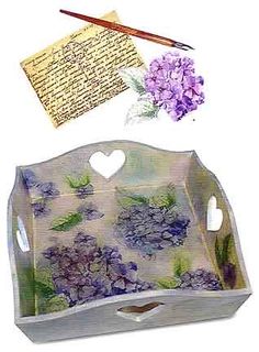 an image of a tray with flowers and writing utensils on it's side