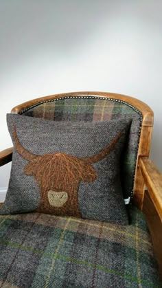 a chair with a pillow that has a cow's head on the back of it