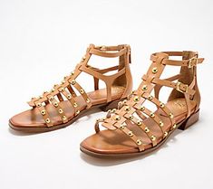 A timeless favorite, these gladiator sandals have a studded detail and two adjustable buckles, instantly elevating them to must-have status for all your summer looks. From Vince Camuto. Trendy Summer Sandals With Rivets, Summer Leather Sandals With Rivets, Spring Beach Sandals With Rivets, Studded Ankle Strap Sandals For Summer, Summer Sandals With Rivets And Round Toe, Leather Sandals With Gold Studs For Spring, Spring Rivets Open Toe Sandals, Spring Open Toe Sandals With Rivets, Summer Beach Sandals With Gold Studs