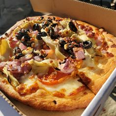 a pizza sitting inside of a box on top of a table