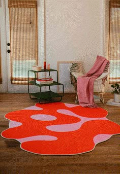 an orange and pink rug in the middle of a room