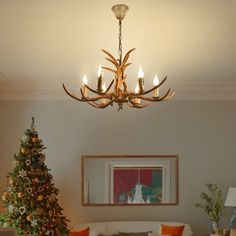 a living room filled with furniture and a christmas tree in front of the couches