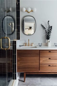 a bathroom with a wooden cabinet and mirror