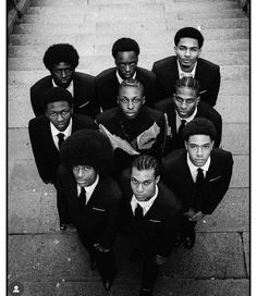 a group of men in suits and ties standing on steps