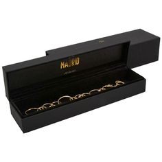 an open black box with gold rings inside