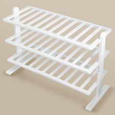 a white shelf with two shelves on each side and one shelf below the shelf for storing items