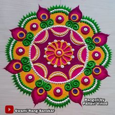 an intricately designed rangdi work with colorful flowers and leaves on white wooden background