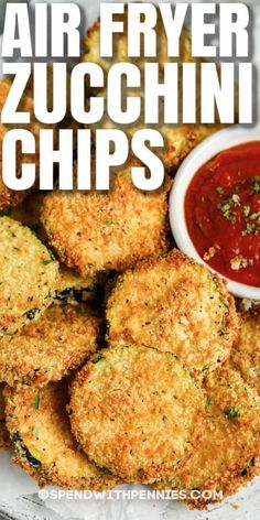 air fryer zucchini chips on a plate with ketchup and dipping sauce