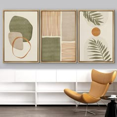 three paintings hang on the wall above a chair and table in a modern living room