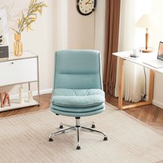 a blue office chair sitting on top of a white rug in front of a window