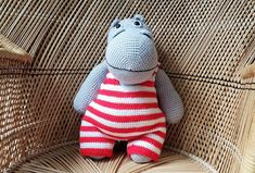 a crocheted hippo sitting on top of a wicker chair