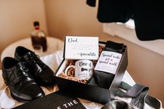 the groom's shoes are sitting on the bed next to the card and tie