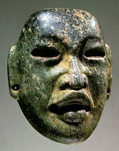 an ancient mask is on display in a museum