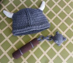 a crocheted hat with horns is next to a knitted toy