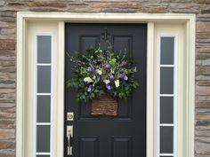 a front door with a basket full of flowers