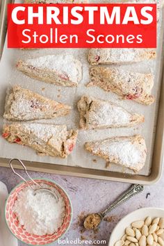 christmas scones on a baking sheet with powdered sugar and nuts next to them