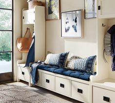 a white bench sitting next to a window filled with lots of pillows and blankets on top of it