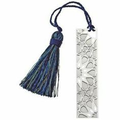 a bookmark with a tassel hanging from it's side and an intricate design on the front