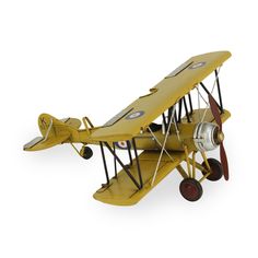 an old model yellow airplane on a white background