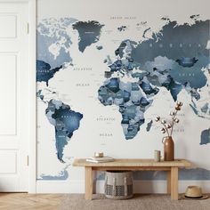 a wall with a world map painted on it in a living room next to a table