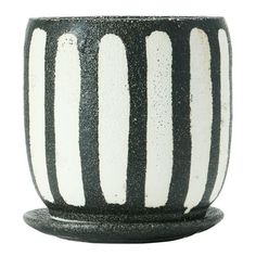 a black and white striped vase sitting on top of a table