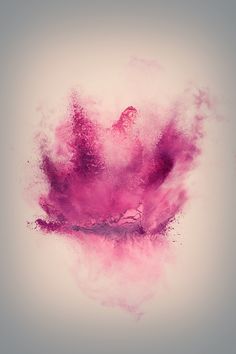 a pink powder explosion in the shape of a crown