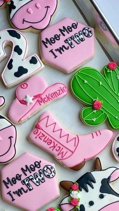 decorated cookies are arranged in the shape of houses and baby's feet with welcome home written on them