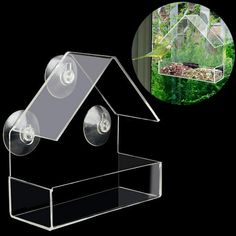 a clear bird house with two lights on it's side and a black background