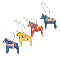 three colorful wooden horses hanging from strings