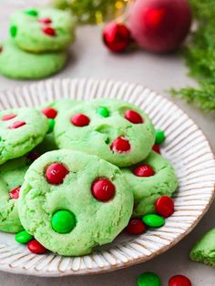 green christmas cookies with red and green sprinkles on a plate