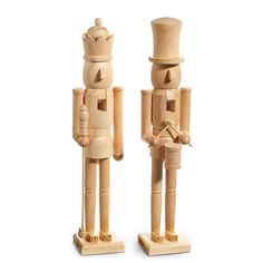 two wooden nutcrackers standing next to each other