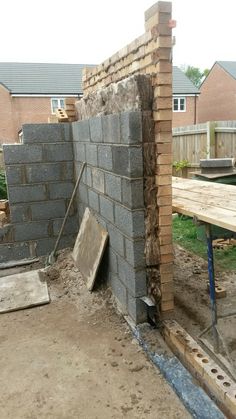 a brick wall is being built in the back yard