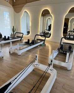 an empty gym with mirrors and treadmills