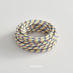 multicolored braiding cord on white background with the word brighttta written in black