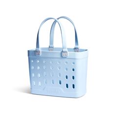 a blue shopping basket with handles on the front and bottom, sitting against a white background