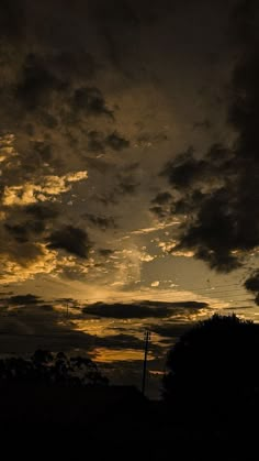 the sky is dark and cloudy at night, with some clouds in the foreground