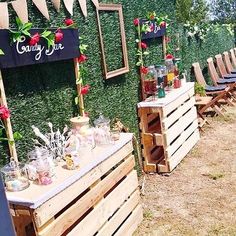 a row of wooden crates sitting next to each other on top of a grass covered field