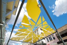 a yellow umbrella sitting on the side of a building