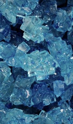 blue glass chips are piled on top of each other