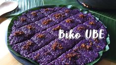 a purple cake is sitting on a plate with the words bike ube written in white